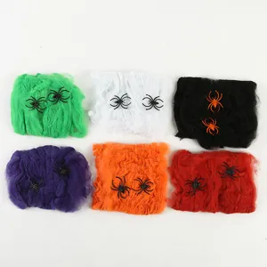 Halloween spider web decoration gauze detail, colorful props with plastic spiders.