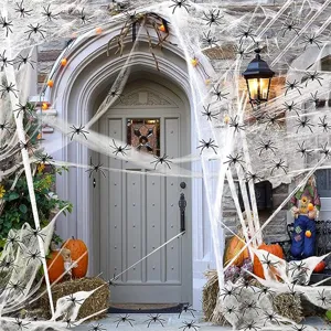 Detailed view of Halloween spider web decorations and fake plastic spiders for spooky party.