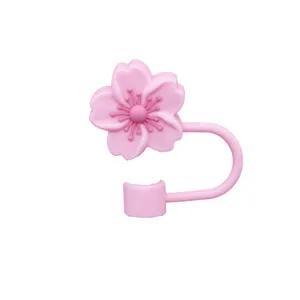 Pink silicone flower straw cover detail showing floral topper and flexible ring for cups.
