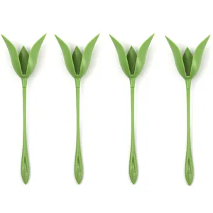 Detail view of four green tulip-shaped napkin folding tools, elegant table decor accessory.