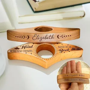 Wooden thumb book page holder detail view showing personalized engraved names and quotes.