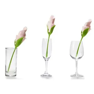 Close up detail of creative flower stem napkin holder displaying elegantly in various glasses.