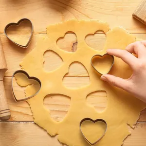 Stainless steel heart-shaped cookie cutters for baking biscuits, pastries, and cutting fruit safely.