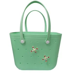 Mint green EVA beach bag with holes and cute rotating windmill charms for daily use.