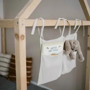 Linen bedside hanging organizer with double pockets for baby crib, nursery storage bag.