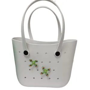 Close-up detail of white EVA beach tote bag featuring dual handles and cute colorful windmill accessories.