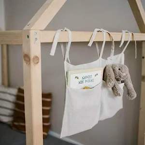 Linen bedside hanging storage bag with double pockets for baby crib, diapers, toys and essentials.