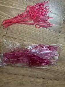 Close-up detail view of novelty pink loop drinking straws for fun party supplies and decorations.