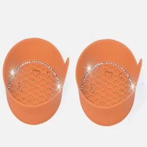 Silicone car cup holder coaster detail showing orange honeycomb pattern with sparkling rhinestones.