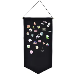 Enamel pin display banner detail showing black fabric board with cute decorative badges.