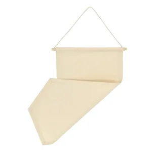 Blank canvas pennant banner detail view, natural cotton fabric with wooden hanging rod.
