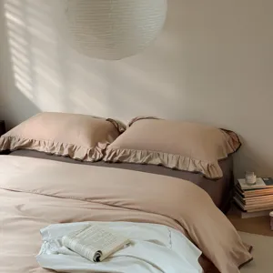 Cotton solid color bedding set detail view, showing soft ruffled pillowcases and duvet cover.
