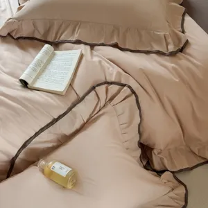 Cotton solid color bedding set with ruffle edge and dark brown piping, cozy bedroom decor.