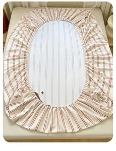 Striped oval fitted sheet made of soft cotton with elastic edge, cozy bedroom bedding decor.