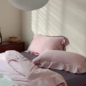 Pure cotton four-piece bedding set with elegant ruffle design for cozy bedroom decor.