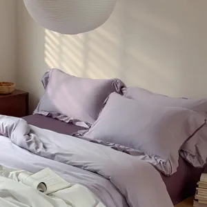 Lavender purple cotton bedding set with ruffled edge duvet cover and sheets for cozy bedroom.