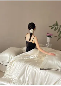 Detailed view of luxury silk cooling bedding set showcasing smooth jacquard fabric texture.