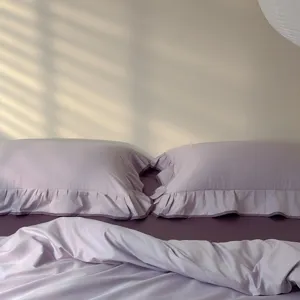 Detail view of the elegant lavender ruffled bedding set, showcasing soft fabric texture and cozy design.