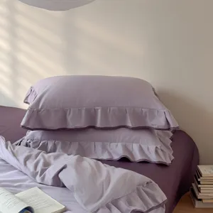Purple cotton bedding set with elegant ruffle design, solid color duvet cover and pillowcases.