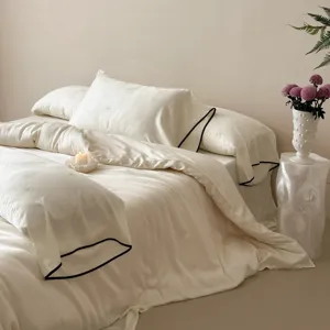 Luxurious 100-count Tencel duvet cover set with elegant black piping and jacquard.