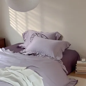 Solid color cotton bedding set with ruffle design, soft purple duvet cover and sheets.