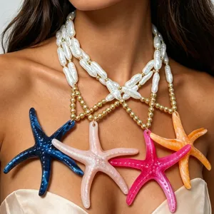 Close-up detail of colorful starfish pendants and white faux pearls on a beach style necklace