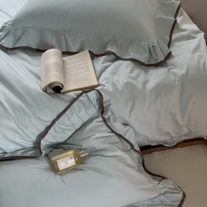 Close-up detail of soft bedding duvet cover featuring elegant brown piping and ruffles, cozy.