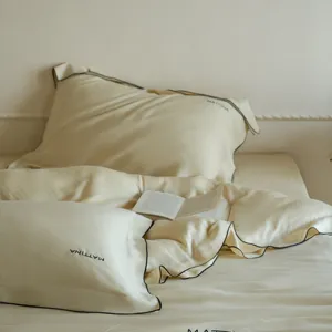 Luxurious Tencel bedding detail, smooth ice silk pillowcase with elegant embroidery.
