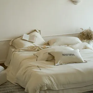 Luxurious washed tencel 4-piece bed set, minimalist beige solid color silky soft bedding detail.