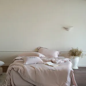 Luxury sand-washed Tencel bedding detail view, showing smooth silky pink duvet and pillow.