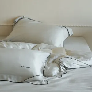 Close-up detail of the luxury washed tencel bedding pillowcase with black piping.