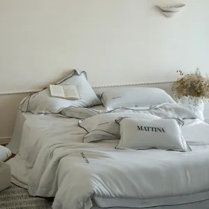 Luxurious tencel 4-piece bedding set featuring elegant black piping and modern style.