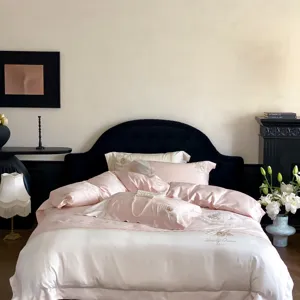 French luxury pink and white jacquard sateen bedding set detail view with fine embroidery.