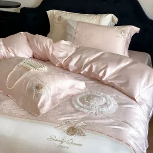 French luxury jacquard sateen four-piece bedding set, pink silky cotton sheet detail view.