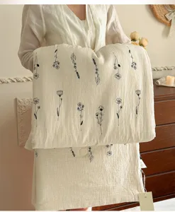 Natural cotton linen summer quilt with elegant black floral embroidery, breathable bedding.