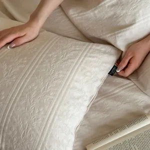 Close-up detail of luxury beige jacquard cotton pillowcase showcasing fine texture and weave.