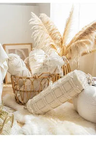 Bohemian cylindrical cotton linen pillow detail, textured bolster with tassels, cozy home.