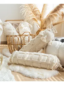 Bohemian cylindrical bolster pillow with tassels, textured neutral decor cushion for sofa and living room.