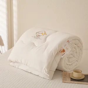 Sojavezel dekbed detail met zachte gewatteerde textuur en label, warme creme kleurige beddengoed set.