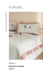 Double washed cotton summer cool quilt with delicate floral embroidery and pink ruffles.