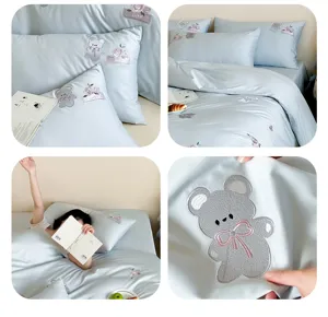 Cute grey bear embroidered bedding set detail, light blue cotton duvet cover and pillowcases.
