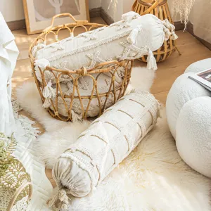 Boho cylindrical decorative pillow with tassels and textured tufting for sofa and living room.