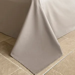Close-up detail of pure cotton jacquard bedding fabric showing elegant texture and drape.
