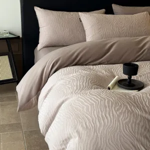 Luxury taupe cotton jacquard bedding detail showcasing elegant textured fabric design.