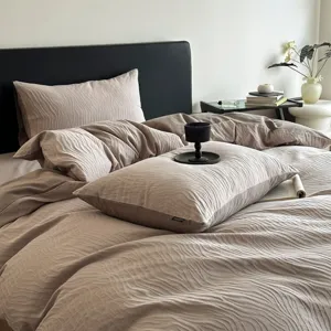 Detail shot of textured taupe jacquard bedding set showing delicate fabric waves and luxury vibe.