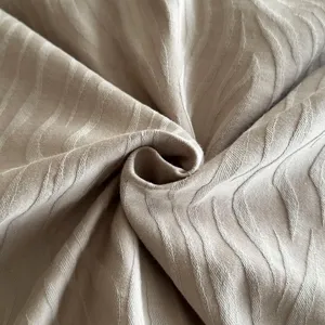 Detailed shot of thick woven pure cotton jacquard fabric with elegant wave pattern texture.
