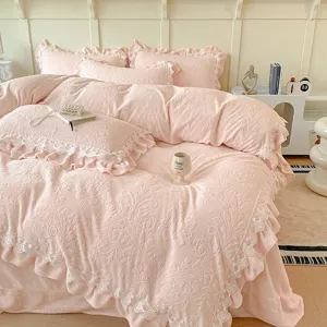 Detalle de ropa de cama de felpa de leche en relieve rosa con elegante ribete de encaje.