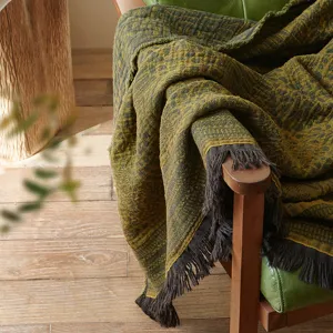 Vintage cotton jacquard throw blanket detail showing intricate texture and elegant fringe edge.