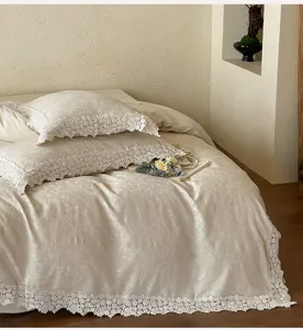 French jacquard cotton linen bedding detail with delicate white lace trim and cozy bedroom vibe.