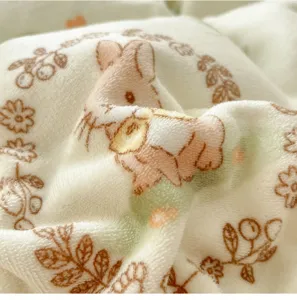 Soft milk fleece bedding blanket close-up detail with rabbit and floral print design.